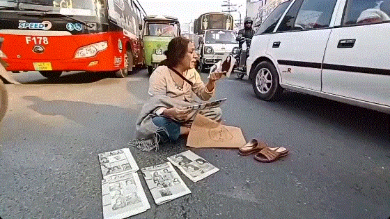 Elderly woman sits in oncoming traffic to protest the disappearance of her daughter
